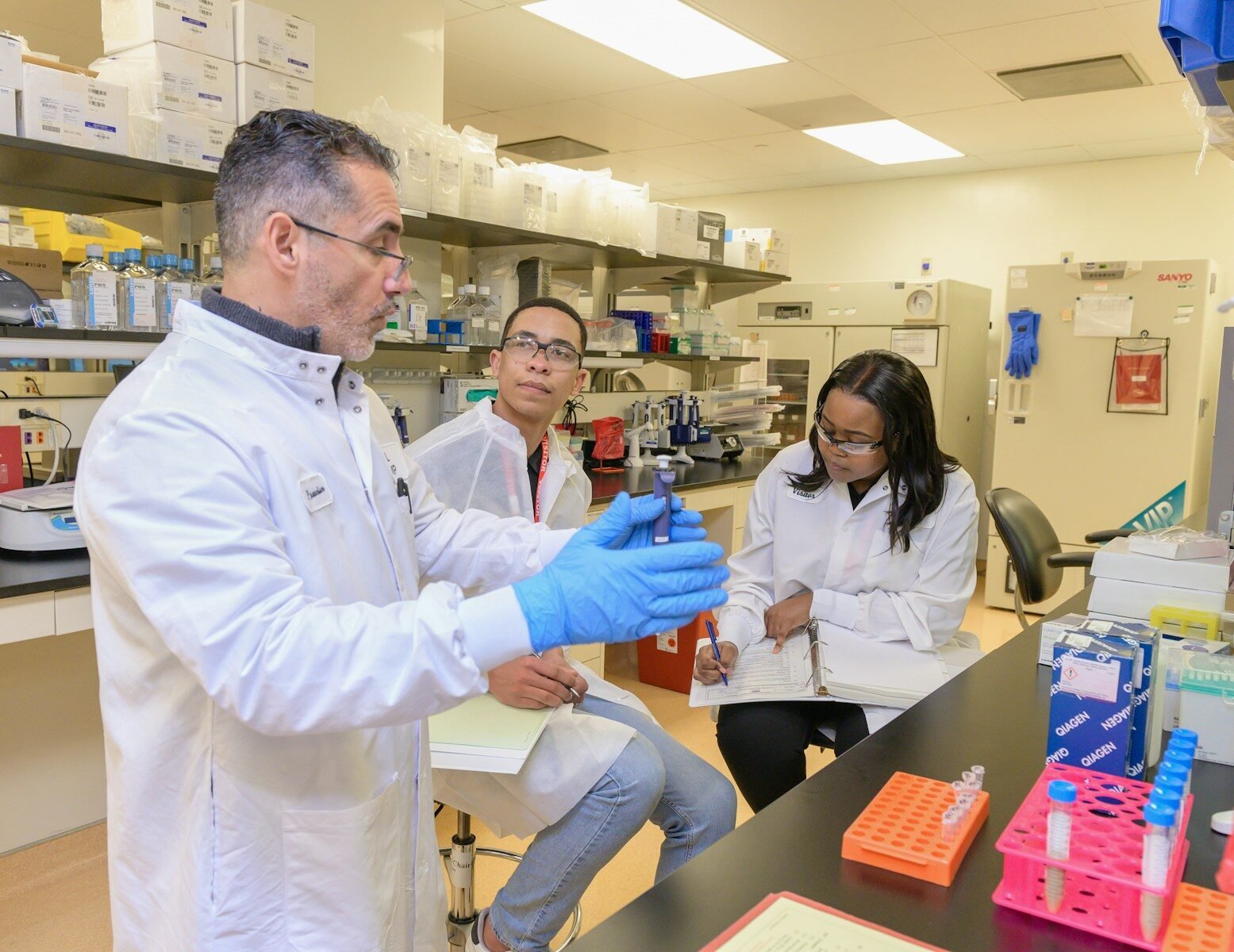 a group of people in a lab looking at something